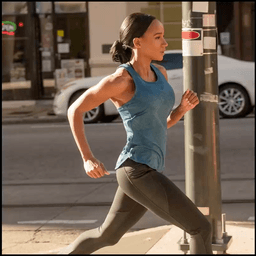 a girl in blue vest is running
