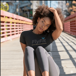 a girl with curly hair is sitting on a bridge floor